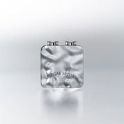 A compact with a built-in mirror and puff, labeled 'Muzigae Mansion', designed for facial blotting with oil paper sheets.