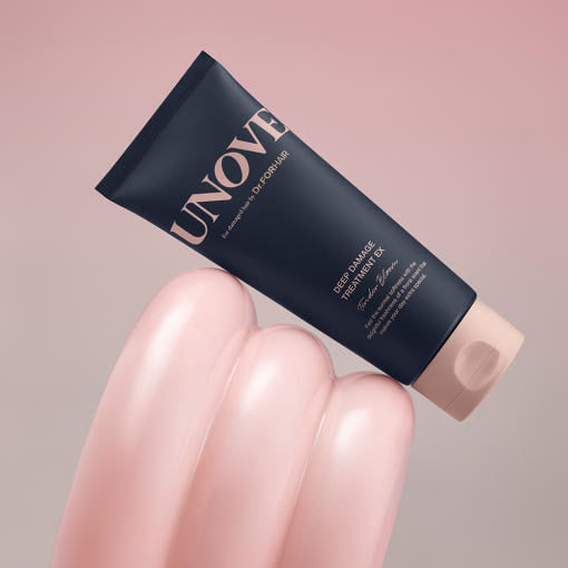 Unover skincare treatment tube held by a hand on a pink background