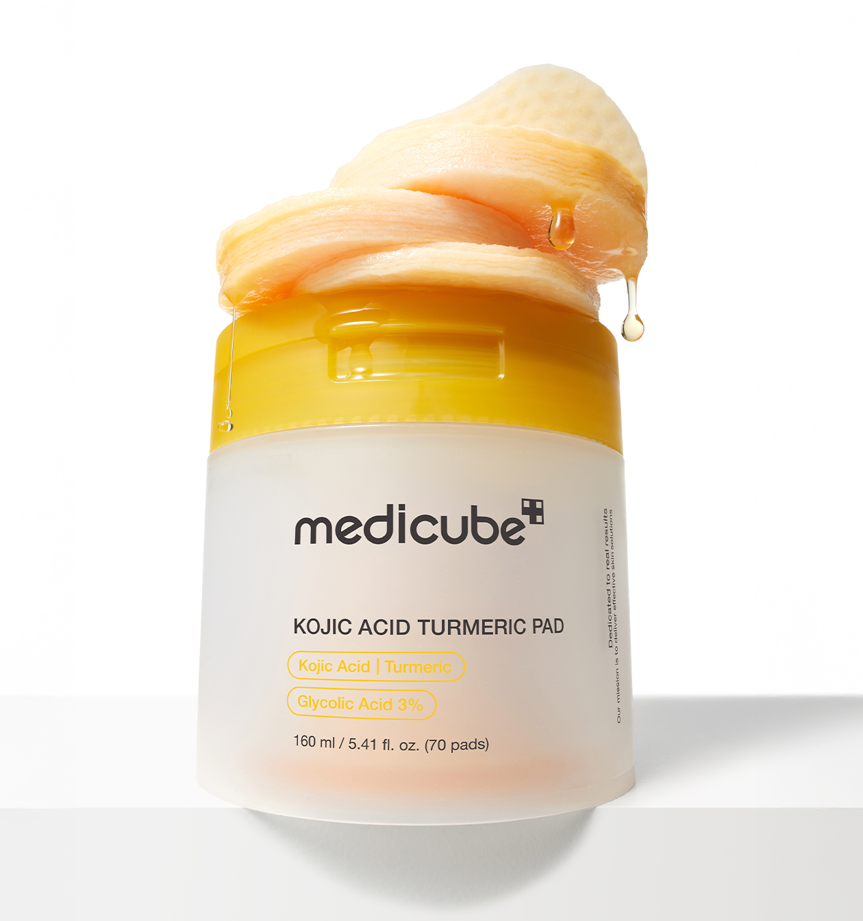 Close-up of medicube Kojic Acid Turmeric toner pads in round container, soft textured pads, Korean brightening skincare