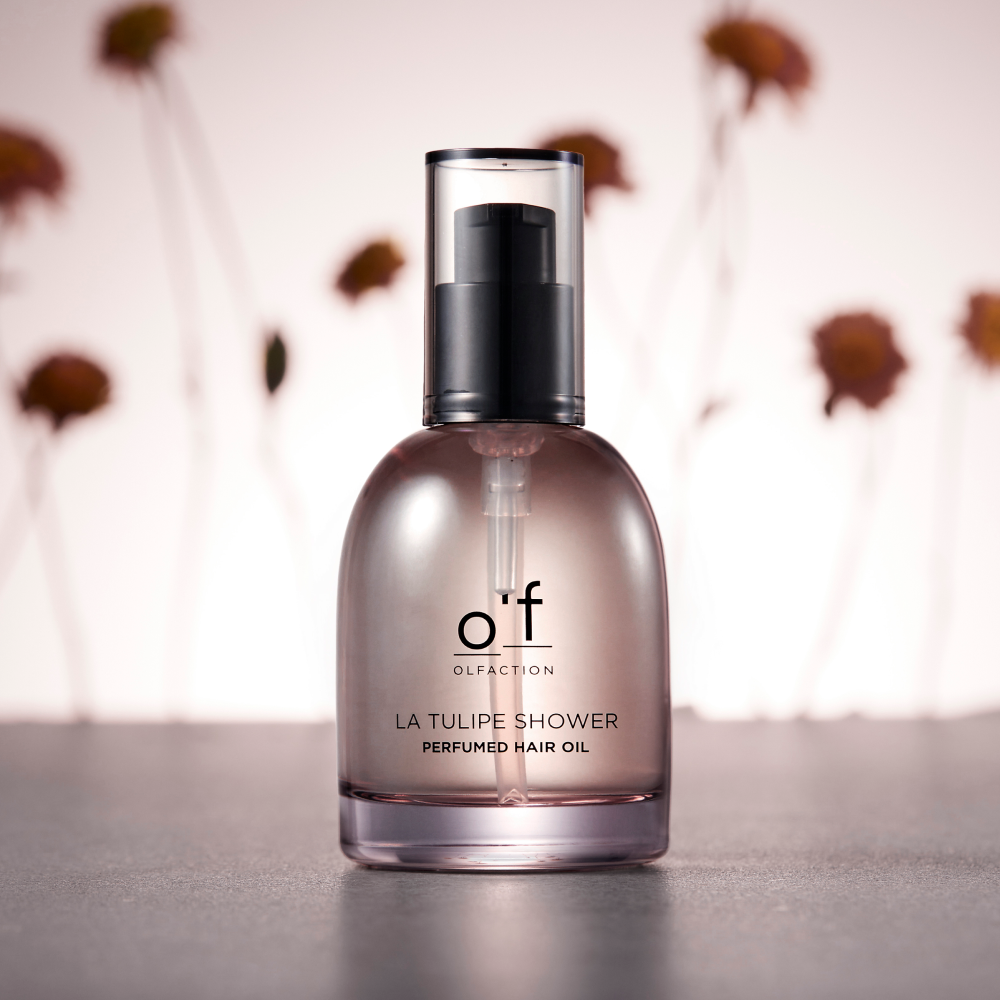 Clear bottle of Kerasys Perfume Hair Oil with pump top, lightweight oil texture, Korean haircare packaging on neutral background