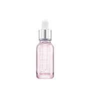 A clear glass ampule bottle with a pink serum visible inside and a dropper tip. The brand's logo is visible on the front, and the bottle has a sleek, elegant design.