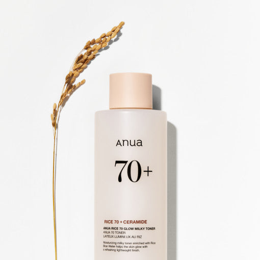 Anua Rice 70 Glow Milky Toner bottle with rice grains and milky liquid, showcasing Korean skincare hydration and brightening benefits.