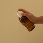 Hand holding a bottle labeled 'Made for Me' with a beige background