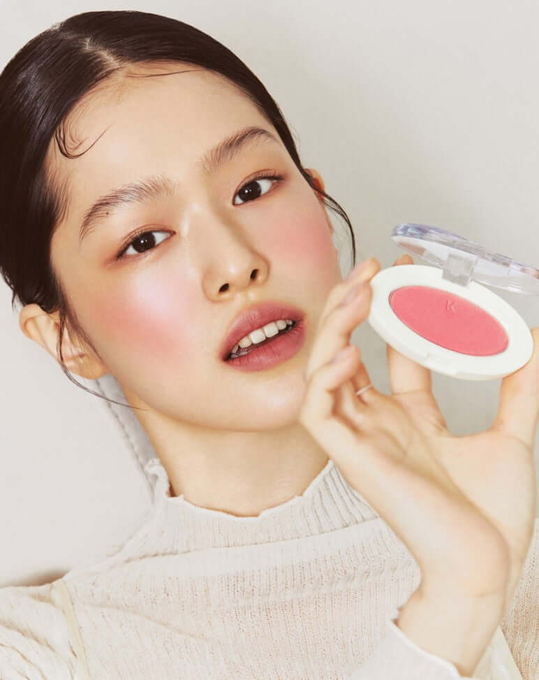 Model showcasing Laka Love Silk Blush, highlighting warm pink tones and radiant complexion with fine pearl reflections.
