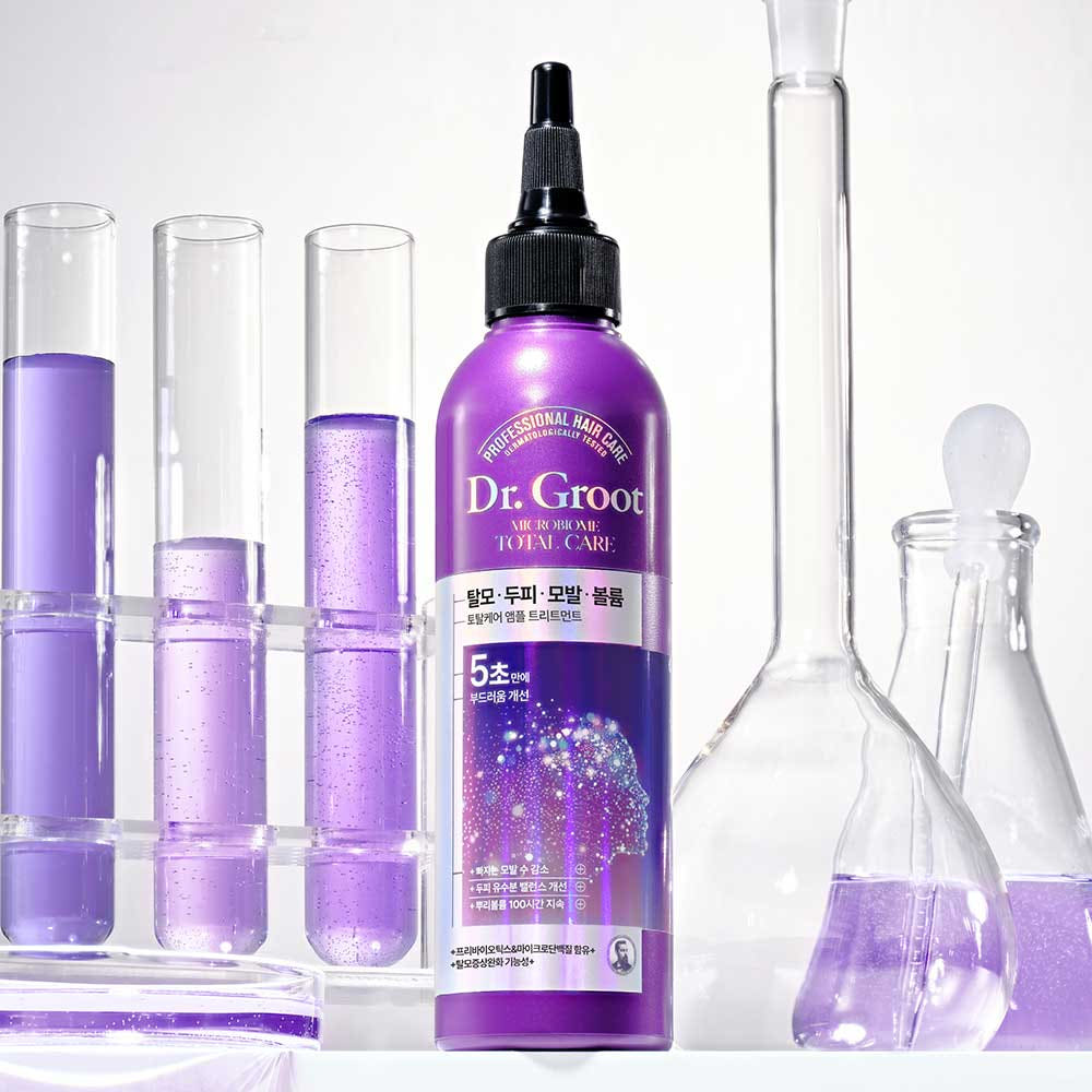 A bottle of Dr.Groot Microbiome Ampoule Treatment designed for hair loss and scalp care, with a purple label and cap.