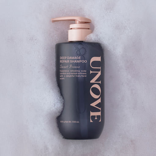 UNOVE Deep Damage Repair Shampoo 500ml in beige bottle with pump, minimal design, placed on neutral-toned surface