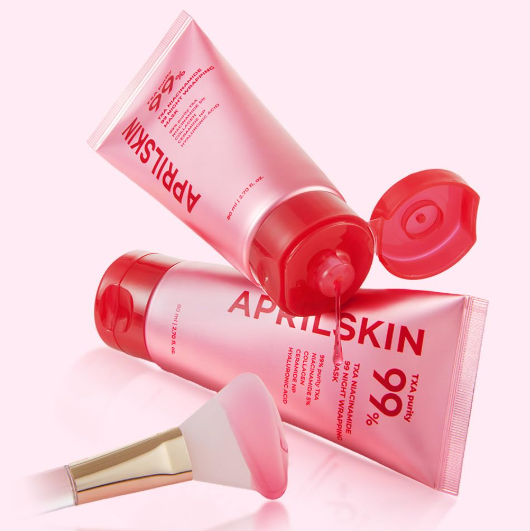 Aprilskin skincare products with a brush on a white background