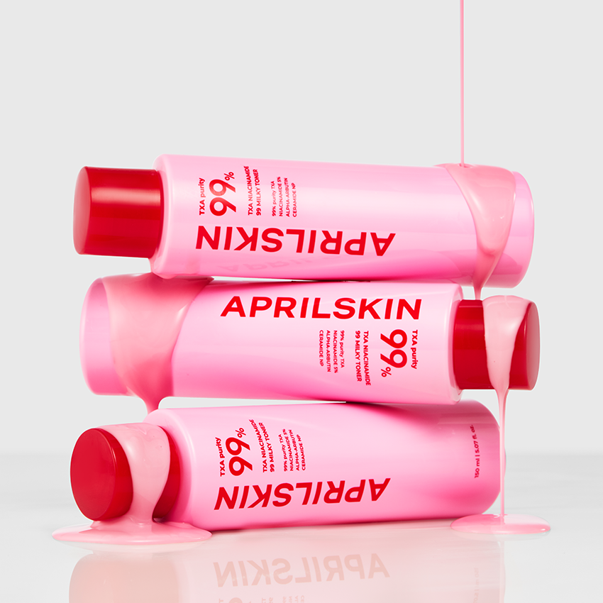 Pink skincare bottle with red cap on a white background