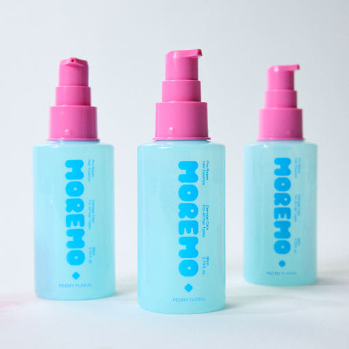 clear bottle of moremo Pro Repair Hair Essence with soft pink label, citrus floral Korean hair treatment, lightweight leave-in formula