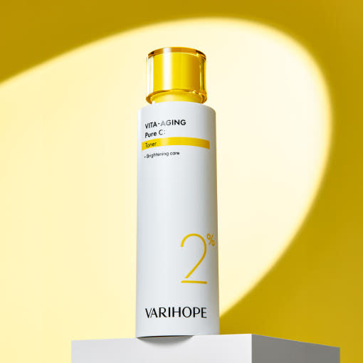 Vita-Aging Pure C toner bottle by Varihope on a yellow background