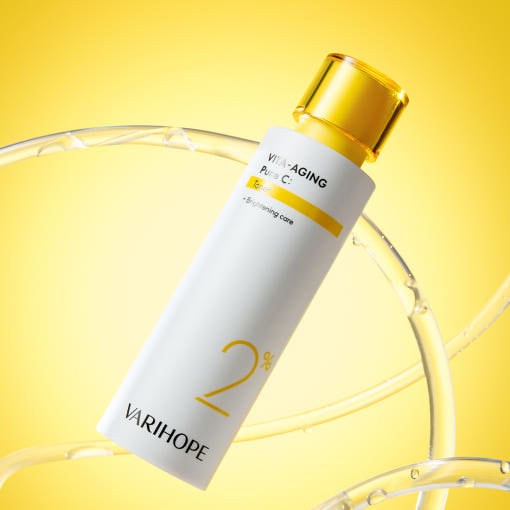 Vita-Aging Pure C toner bottle by Varihope on a yellow background